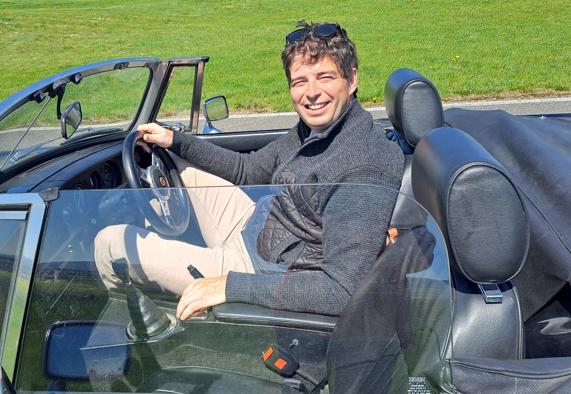Jan Plomer, founder, in a classic convertible